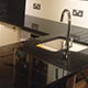 Worktops in 'Steel Grey granite with splash backs in white quartz Worktops in 'Steel Grey granite with splash backs in white quartz